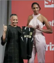  ?? THE ASSOCIATED PRESS ?? South Carolina’s A’ja Wilson, right, poses for a photo with WNBA President Lisa Borders after being selected as the No. 1overall pick by the Las Vegas Aces in the WNBA basketball draft, Thursday in New York.