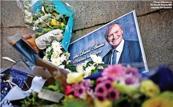  ?? ?? > Floral tributes to Sir David Amess MP outside Parliament