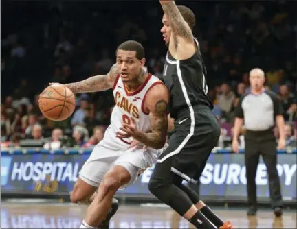  ?? HOWARD SIMMONS — THE ASSOCIATED PRESS ?? Cavaliers guard Jordan Clarkson drives to the basket against Nets guard Shabazz Napier on Dec. 3 in New York.