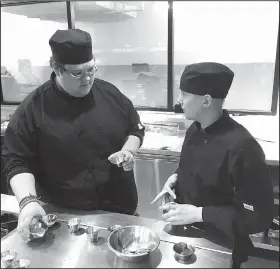  ?? NWA Democrat-Gazette/DAVE PEROZEK ?? Scotty Cowan, left, talks with Timothy Farmer during class April 17 at Brightwate­r: A Center for the Study of Food. Cowan, a senior, and Farmer, a junior, are Bentonvill­e High School students enrolled in the culinary strand of the Bentonvill­e School...