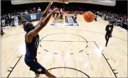  ?? AP PHOTO BY CHRIS PIZZELLO ?? Indiana Pacers' Victor Oladipo dunks while wearing a mask from the movie “Black Panther” during the NBA basketball All-star weekend slam dunk contest Saturday in Los Angeles.