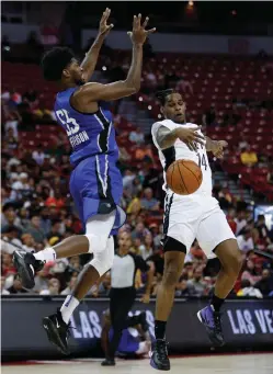  ?? John Locher/Associated Press ?? ■ Brooklyn Nets’ Ahmed Hill, right, blocks a pass from Orlando Magic’s Amile Jefferson on Wednesday during the second half of an NBA Summer League game in Las Vegas.