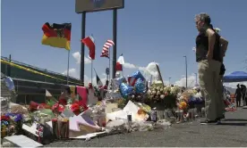  ??  ?? Mourners visit the makeshift memorial near the Walmart in El Paso, Texas, where 22 people were killed in a mass shooting. Photograph: Cedar Attanasio/AP