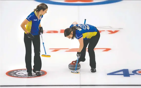  ?? ANDREW KLAVER/SPECIAL TO POSTMEDIA// ?? Team Alberta lead Rachel Brown, left, and third Kate Cameron sweep in Draw 17 at the Scotties Tournament of Hearts on Thursday in Calgary.