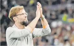  ??  ?? Liverpool manager Jurgen Klopp applauds the fans after the Champions League semi-final second leg match against AS Roma at the Olympic Stadium in Rome. — AFP photo