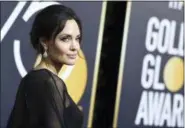  ?? PHOTO BY JORDAN STRAUSS — INVISION — AP, FILE ?? In this file photo, Angelina Jolie wears Forevermar­k Diamond earrings at the 75th annual Golden Globe Awards in Beverly Hills on Jan. 7.