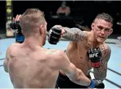  ?? GETTY IMAGES ?? Dustin Poirier connects with Kiwi Dan Hooker during their middleweig­ht fight in Los Angeles yesterday.