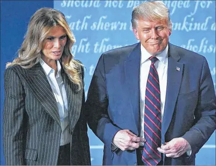  ?? Saul Loeb / TNS ?? President Donald Trump and US First Lady Melania Trump leave after the first presidenti­al debate Tuesday.