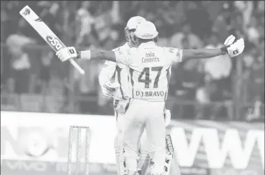  ??  ?? Dwayne Bravo and Mahendra Singh Dhoni celebrate their team’s victory over Royal Challenger­s Banglaore. (Photo courtesy of IPL website)