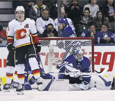  ?? JACK BOLAND ?? Calgary’s Sean Monahan celebrates after scoring a power-play goal on Maple Leafs goalie Frederik Andersen Monday at the Scotiabank Arena in Toronto. The Flames were 3-1 winners.