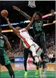  ?? STUART CAHILL / BOSTON HERALD FILE ?? Robert Williams forces Miami’s Kyle Lowry to fall back off his shot in Game 6 of the Eastern Conference Finals at TD Garden on Friday.