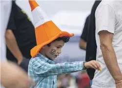  ?? ?? Members of the Fulton Hogan team dressed as road cones.