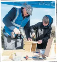  ?? ?? A young visitor helps to make a bird box at the Seend Lock open day.