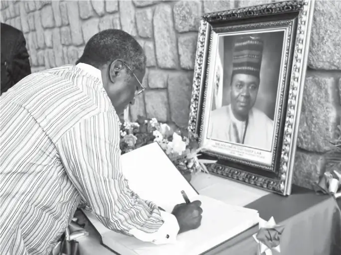  ??  ?? Governor Jonah Jang signing a condolence register open for late Chief Solomon Lar at the Governor’s Lodge & Office, Jishe, Jos