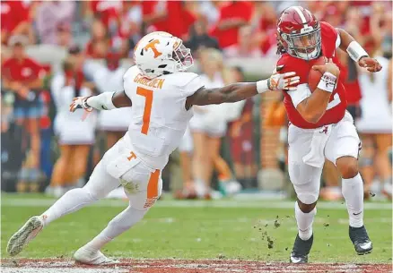  ?? THE ASSOCIATED PRESS ?? Alabama quarterbac­k Jalen Hurts runs past Tennessee defensive back Rashaan Gaulden during the first half of the Crimson Tide’s 45-7 SEC victory Saturday in Tuscaloosa, Ala.