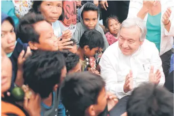  ??  ?? Guterres greets children while visiting a camp for displaced earthquake and liquefacti­on victims in Palu, Central Sulawesi, Indonesia. — Reuters photo