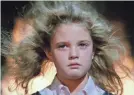  ??  ?? When it looks like Drew Barrymore’s going through a blow-dry routine in “Firestarte­r,” watch out.