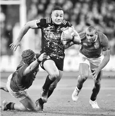  ?? — AFP photo ?? Wellington Hurricanes’ Ngani Laumape (centre) is tackled by British and Irish Lions’ James Haskell (left) and Jonathan Joseph during their rugby union match at Westpac Stadium in Wellington.