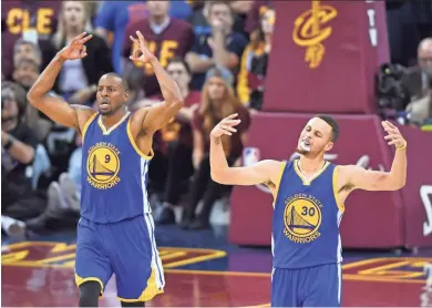  ?? KEN BLAZE/USA TODAY SPORTS ?? Warriors guard Stephen Curry (30) and forward Andre Iguodala celebrate after a 3-pointer against the Cavaliers in Cleveland on Friday night.