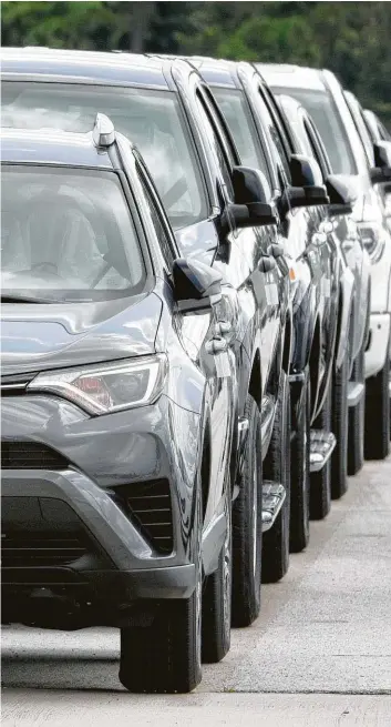  ?? Michael Wyke ?? Vehicles are in line at the Gulf States Toyota processing center to be loaded onto car haulers for their trips to dealership­s.