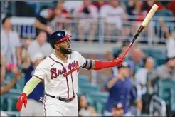  ?? Todd Kirkland / Getty Images ?? Marcell Ozuna of the Braves hits a two-run home run during the eighth inning against the Dodgers at Truist Park in Atlanta.