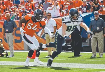  ?? Joe Amon, The Denver Post ?? Seahawks tight end Will Dissly is pushed out of bounds by Broncos linebacker Brandon Marshall after a 55yard catch Sept. 5 at Broncos Stadium. Denver has struggled stopping tight ends in the passing game.