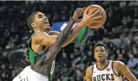  ??  ?? Celtics guard Jayson Tatum drives past the Bucks’ Tony Snell on Thursday in Milwaukee.