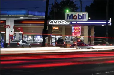  ?? AP PHOTO/PAUL SANCYA ?? Motorists stop for fuel at gas stations in Detroit on Tuesday.