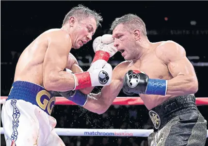  ??  ?? Gennady Golovkin, left, exchanges punches with Sergiy Derevyanch­enko during their IBF middleweig­ht title bout at Madison Square Garden.