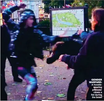  ??  ?? GENDER WARFARE: A hoodiewear­ing protester raises a fist during the brawl