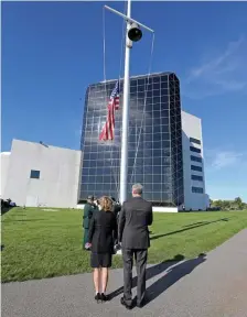  ?? STUART CAHILL / HeRALD STAFF ?? PAYING THEIR RESPECTS: Gov. Charlie Baker and his wife, Lauren, watch the flag being raised at the John F. Kennedy Library during a ceremony to commemorat­e lives lost 20 years ago during the 9/11 terrorist attacks.