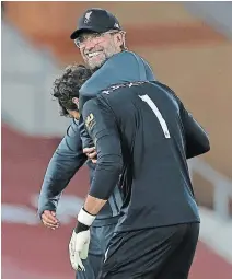  ?? PHIL NOBLE
THE ASSOCIATED PRESS ?? Liverpool manager Jurgen Klopp, pictured back, celebrates with goalkeeper Alisson after an English Premier League soccer match against Crystal Palace at Anfield Stadium.