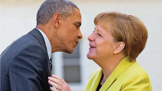  ??  ?? Ein Küsschen zur Begrüßung: Barack Obama und Angela Merkel demonstrie­ren vor Schloss Herrenhaus­en in Hannover ihre Verbundenh­eit.