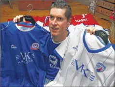  ?? Picture: Andy Jones FM4721111 ?? Kieran McAuliffe with favourite Chesterfie­ld player Dan Jones. Kieran, pictured with some of the team’s shirts, has a season ticket and travels to all home and away games