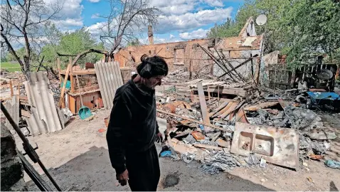  ?? | EPA ?? A MAN stands near the rubble of his destroyed home in Kozarovych­i village, Ukraine, yesterday. He lost his home after a shot-down military helicopter crashed into it and he and his wife have to live in a bomb shelter. According to the UN, more than 6 million refugees have fled Ukraine since Russia’s February invasion and a further 7.7 million people have been displaced internally within the country.