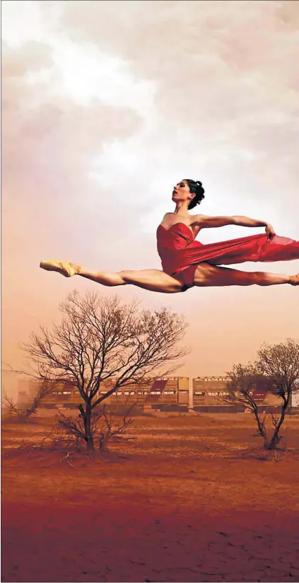  ?? ?? Ballet star Leanne Benjamin takes flight above a road train in Alice Springs in her native Australia in 2006
Picture Jason Bell