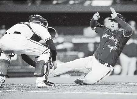  ?? NICK WASS THE ASSOCIATED PRESS ?? Toronto Blue Jays’ Aledmys Diaz, right, is out at the plate against Orioles catcher Caleb Joseph, left, during the eighth inning Monday in Baltimore.