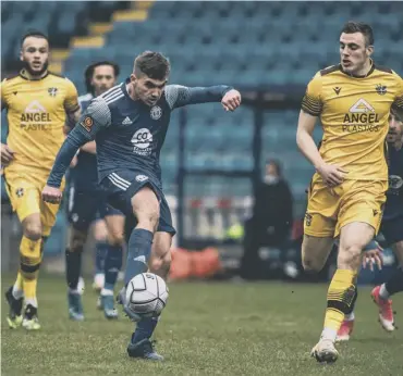  ??  ?? GOING FOR GOAL: Billy Chadwick has an effort in Saturday’s 2-2 draw against leaders Sutton at The Shay. Photo: Marcus Branston.