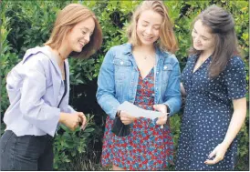  ?? (Photo: Katie Glavin) ?? Caitlin Duffy, Hannah Fenton and Moya Keane deliberati­ng CAO points on results day.