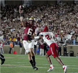  ?? Ap filE ?? IN HIS FACE: Boston College quarterbac­k Dennis Grosel passes under pressure from North Carolina State cornerback Derrek Pitts Jr. during the first half on Saturday.