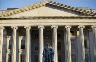  ?? PABLO MARTINEZ MONSIVAIS — THE ASSOCIATED PRESS FILE ?? This photo shows the U.S. Treasury Department building in Washington. The federal government collected a record amount of tax income for the month of November 2017 and also had a record level of spending for the month, producing a budget deficit of...