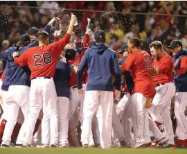  ?? NAncy LAnE PHotoS / HErALd StAFF ?? ONE WIN AWAY: The Red Sox celebrate the game-winning home run by Christian Vazquez during the 13th inning of Game 3 of the ALDS at Fenway Park on Sunday.