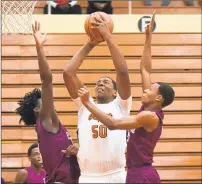  ??  ?? West Side’s Mason Nicholson, center, takes the ball to the basket.