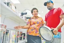  ?? Picture: ELIKI NUKUTABU ?? Courts sales rep Seleima Dilawe (left) markets the Premier Handi pressure cooker to Ravin Raj of Nepani, at Courts Nakasi in Nausori.