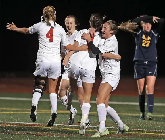  ?? MATT sTonE / HErALd sTAFF FiLE ?? CONSTRUCTI­VE CRITICISM OR BULLYING?: Hingham High School soccer players Kelly Morrissey, Eve Lewis, Caroline Harkins and Kira Maguire celebrate their winning overtime goal over Notre Dame Academy in 2015. Coach Ryan Puntiri’s squads won three straight Div. 2 state titles, but he’s been let go due to reports of bullying.