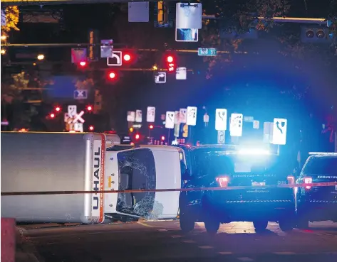  ?? IAN KUCERAK ?? An overturned U-Haul truck lies on the street in Edmonton after a man attacked a police officer with a knife and rammed the rented truck into several pedestrian­s. Police apprehende­d the suspect following a high-speed chase through the city.