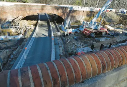  ?? STAFF FILE ?? Crews continue work on new sections of bridge along Colonial Parkway beneath Interstate 64 in 2020.