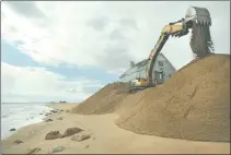  ?? DANA JENSEN/DAY FILE PHOTO ?? An excavator from Cherenzia Excavation scoops sand March 27, 2013, while rebuilding hurricane-damaged dunes in the Misquamicu­t beach area of Westerly behind the Atlantic Beach Casino Resort.