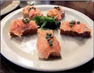  ?? Arkansas Democrat-Gazette/ERIC E. HARRISON ?? Smoked Salmon comes on house-made Irish brown bread with chive butter and capers at Dugan’s Pub.