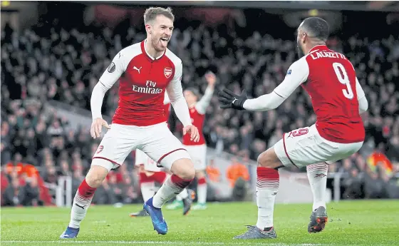  ??  ?? Arsenal’s Aaron Ramsey, left, celebrates with Alexandre Lacazette after scoring against CSKA Moscow.